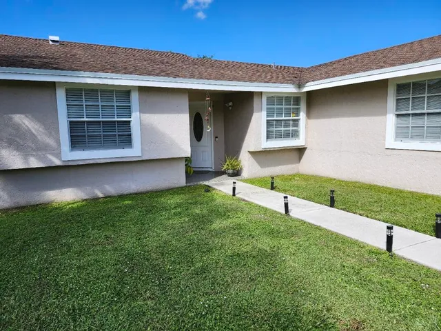 a large kitchen with stainless steel appliances granite countertop a large counter top and a stove