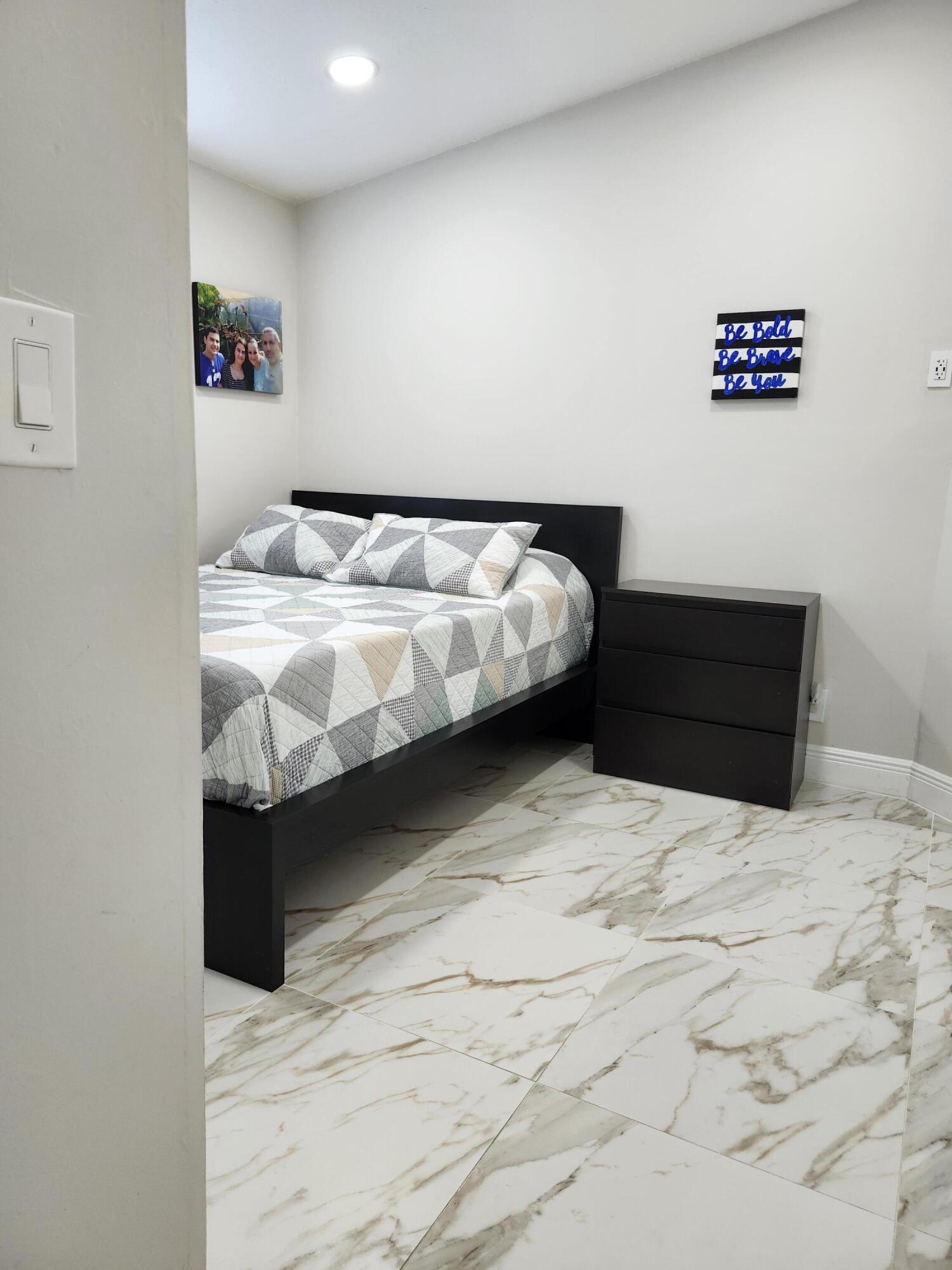 1473 Donwoods Lane Royal Palm Beach, FL 33411 - Photo 51 of 95 a bedroom with a bed and a couch