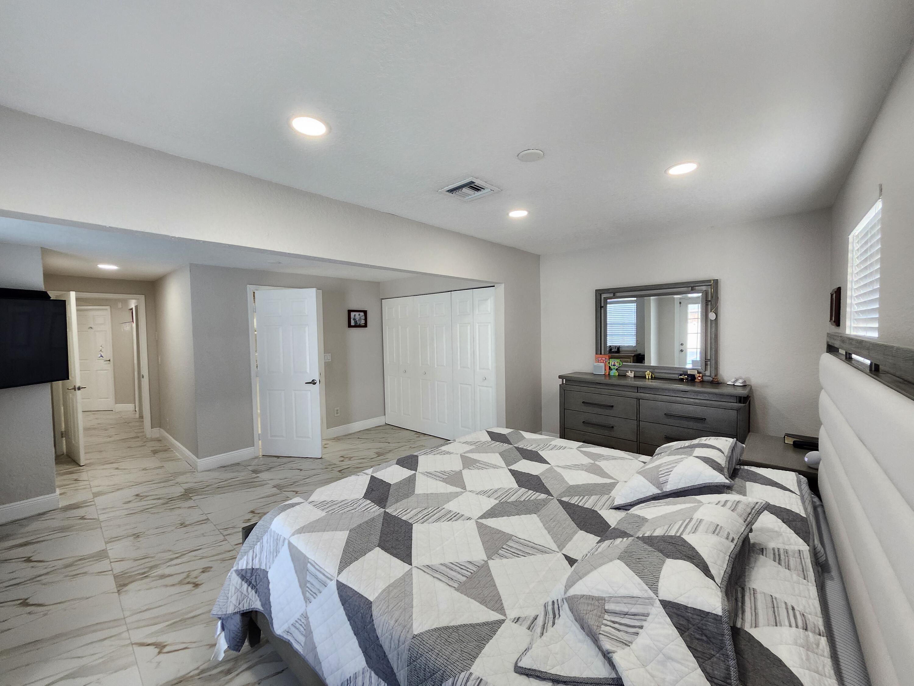 1473 Donwoods Lane Royal Palm Beach, FL 33411 - Photo 69 of 95 a bedroom with a bed and a view of bathroom
