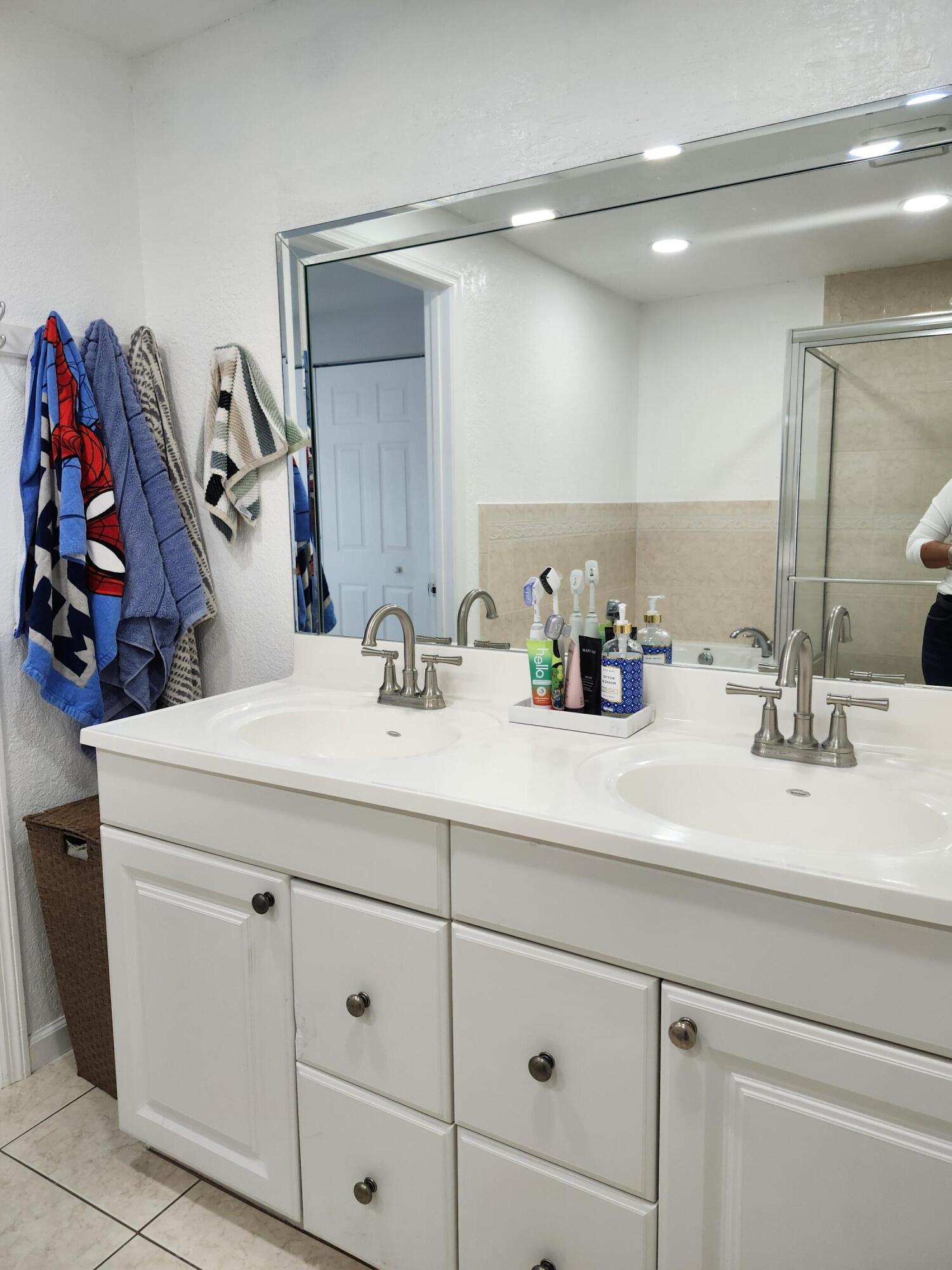 1473 Donwoods Lane Royal Palm Beach, FL 33411 - Photo 73 of 95 a bathroom with a sink double vanity and a mirror
