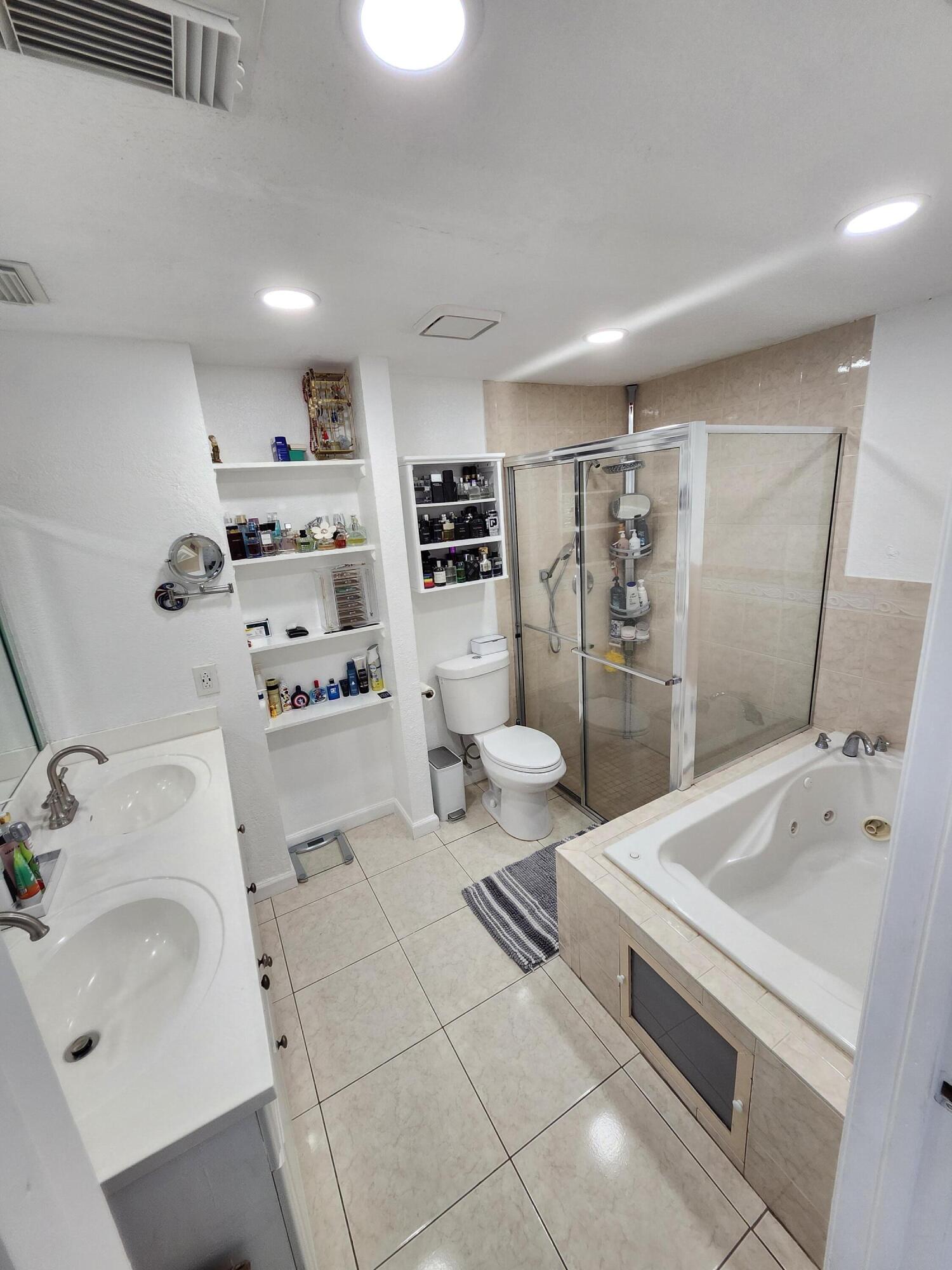 1473 Donwoods Lane Royal Palm Beach, FL 33411 - Photo 79 of 95 a bathroom with a sink a toilet and shower