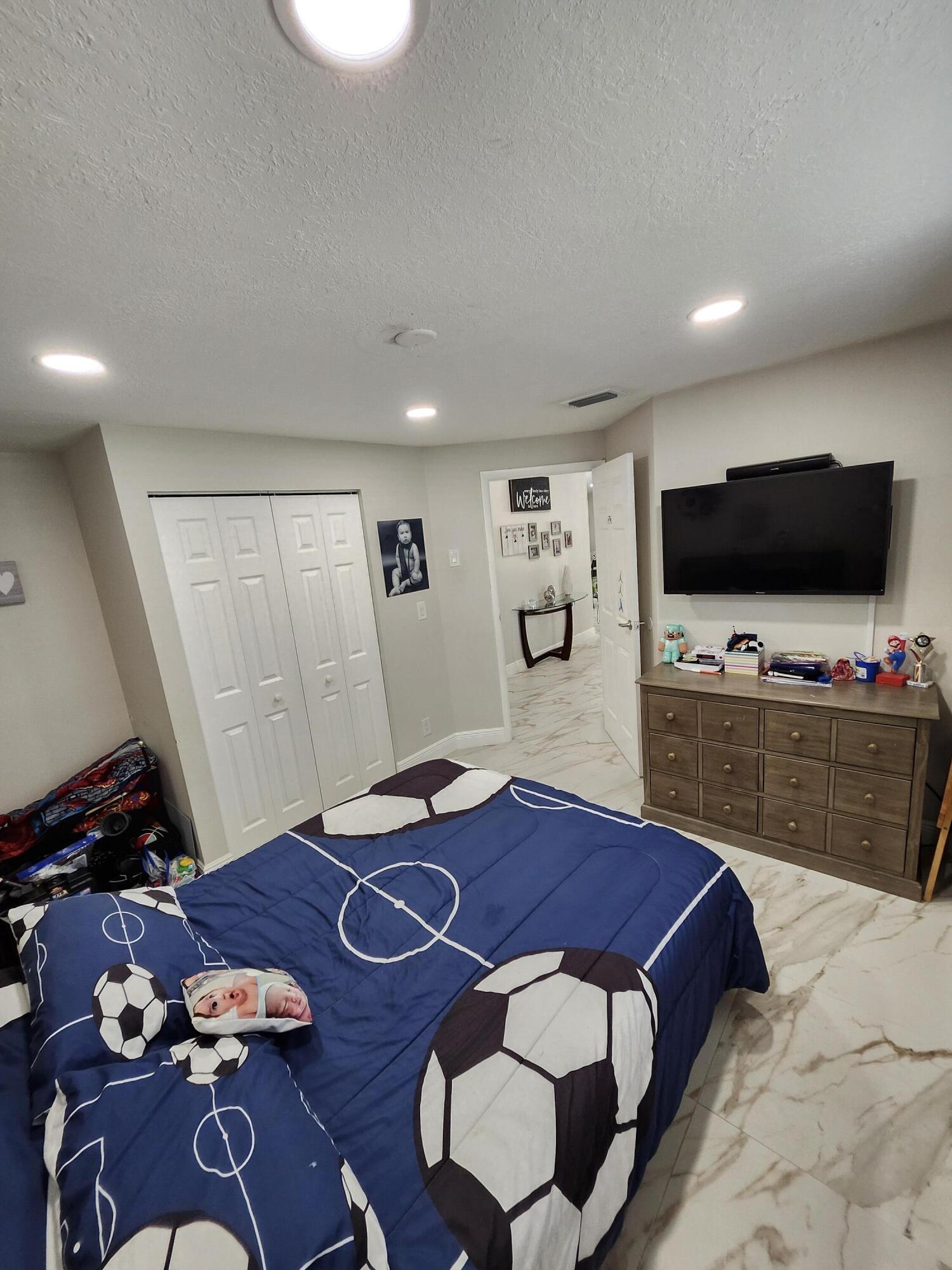 1473 Donwoods Lane Royal Palm Beach, FL 33411 - Photo 89 of 95 a living room with furniture and a flat screen tv