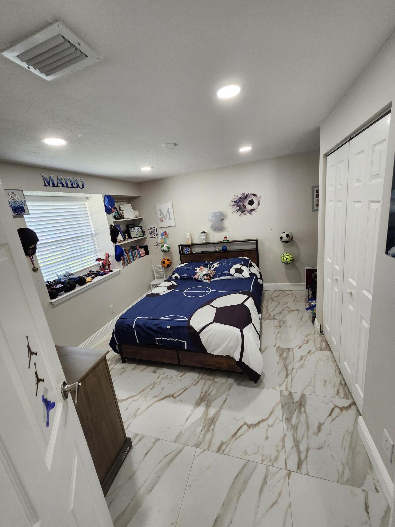 1473 Donwoods Lane Royal Palm Beach, FL 33411 - Photo 91 of 95 a bed room with a bed and a large mirror