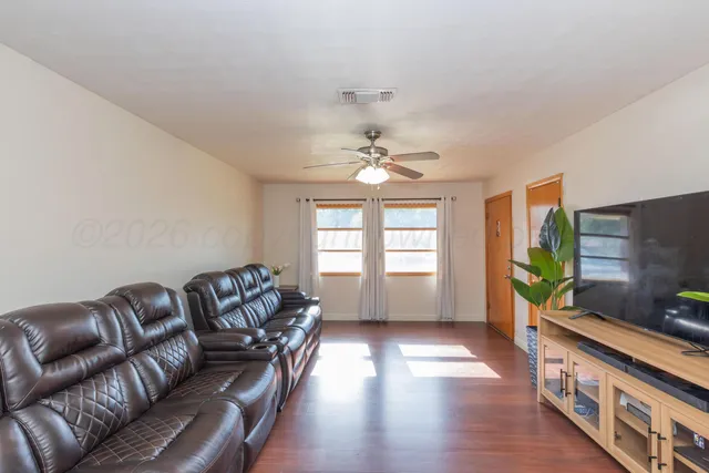 a living room with furniture and a flat screen tv