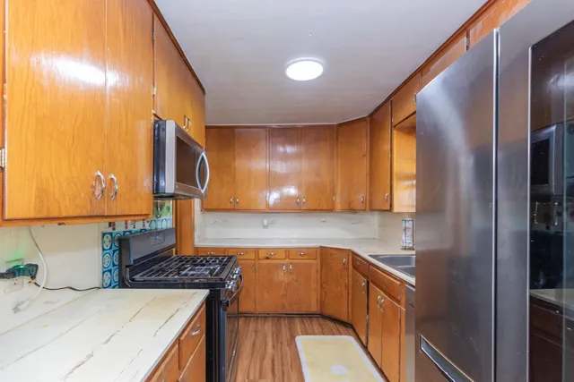 a kitchen with a sink and a refrigerator
