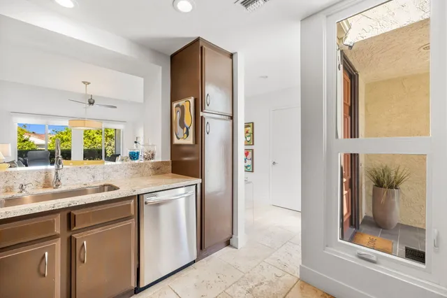 a kitchen with stainless steel appliances granite countertop a refrigerator and a sink