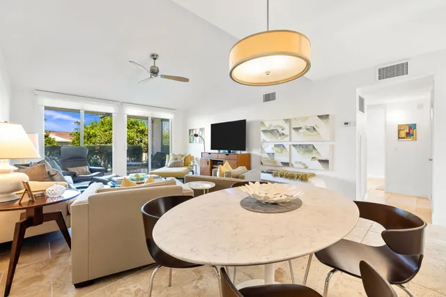 a view of a dining room with furniture and a potted plant