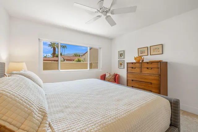 a bedroom with a large bed and a window