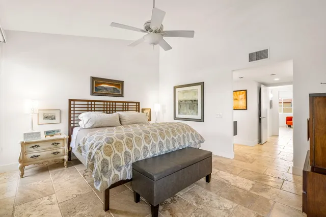 a bedroom with a large bed and a window