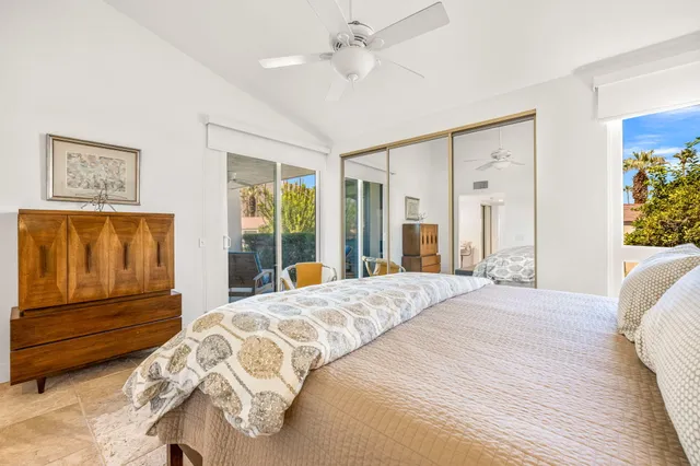 a bedroom with a bed and a dresser next to a window