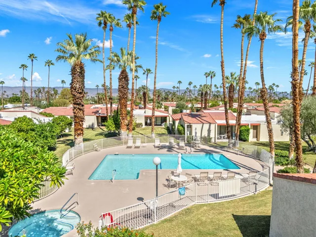 a view of a swimming pool with a table and chairs