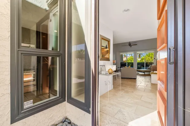 a view of a balcony with furniture and floor to ceiling window