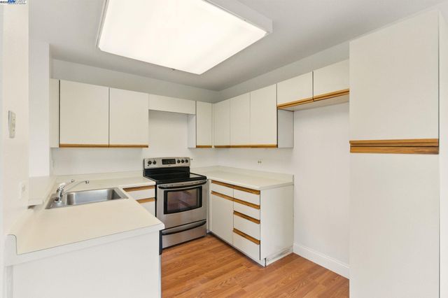 a kitchen with a sink stove and microwave