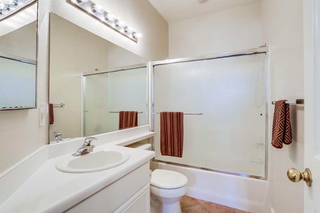 6094 Citracado Circle Carlsbad, CA 92009 - Photo 19 of 28 a bathroom with a sink toilet and shower