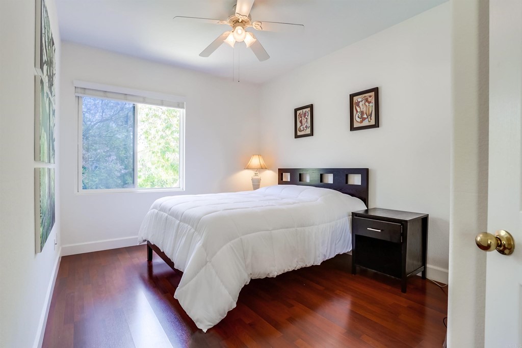 6094 Citracado Circle Carlsbad, CA 92009 - Photo 20 of 28 a bedroom with a bed and wooden floor