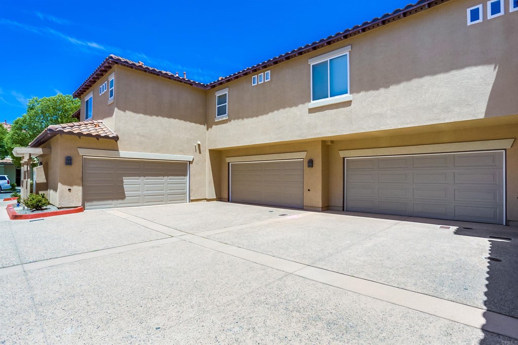 6094 Citracado Circle Carlsbad, CA 92009 - Photo 22 of 28 a front view of a house with yard and garage