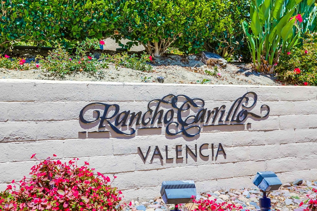 6094 Citracado Circle Carlsbad, CA 92009 - Photo 26 of 28 a street sign that is sitting in front of flowers