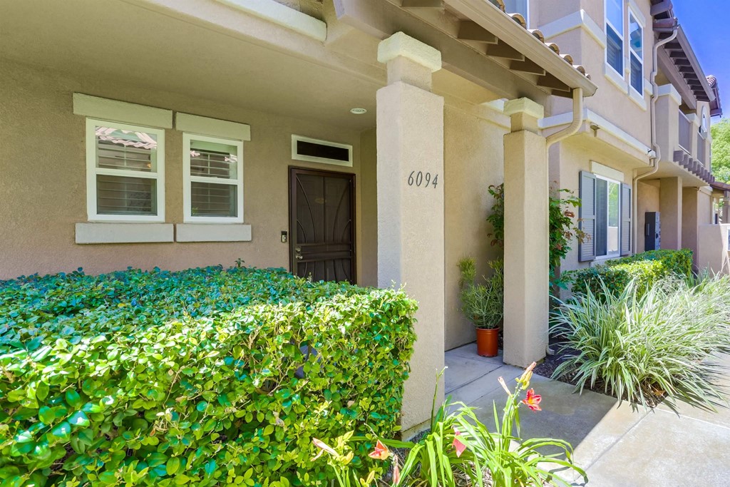 6094 Citracado Circle Carlsbad, CA 92009 - Photo 3 of 28 a front view of a house with a yard