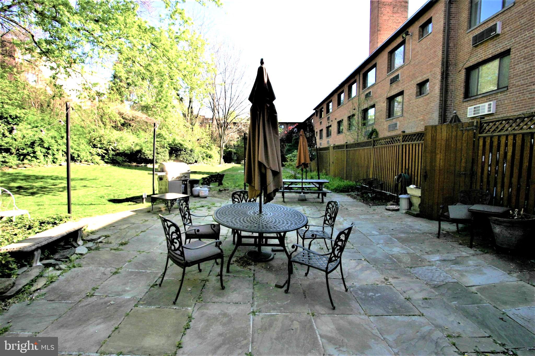 4114 Davis Place Northwest, Unit 210 Washington, DC 20007 - Photo 16 of 19 a view of backyard with outdoor seating and plants