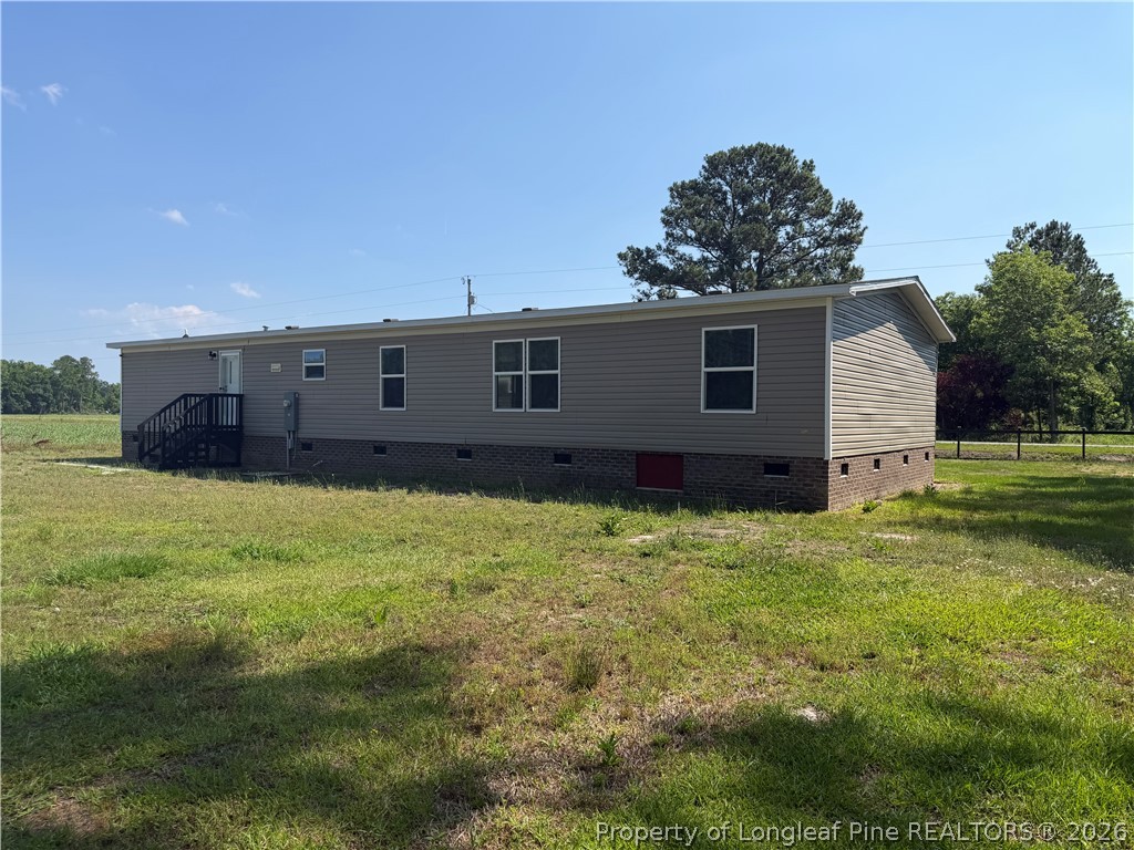 4339 Saddletree Road Lumberton, NC 28360 - Photo 5 of 23 a view of a house with a backyard