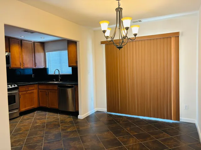 a kitchen with a refrigerator a sink and cabinets