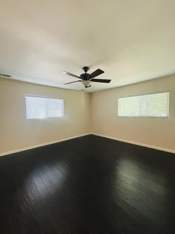 a view of wooden floor and windows in a room