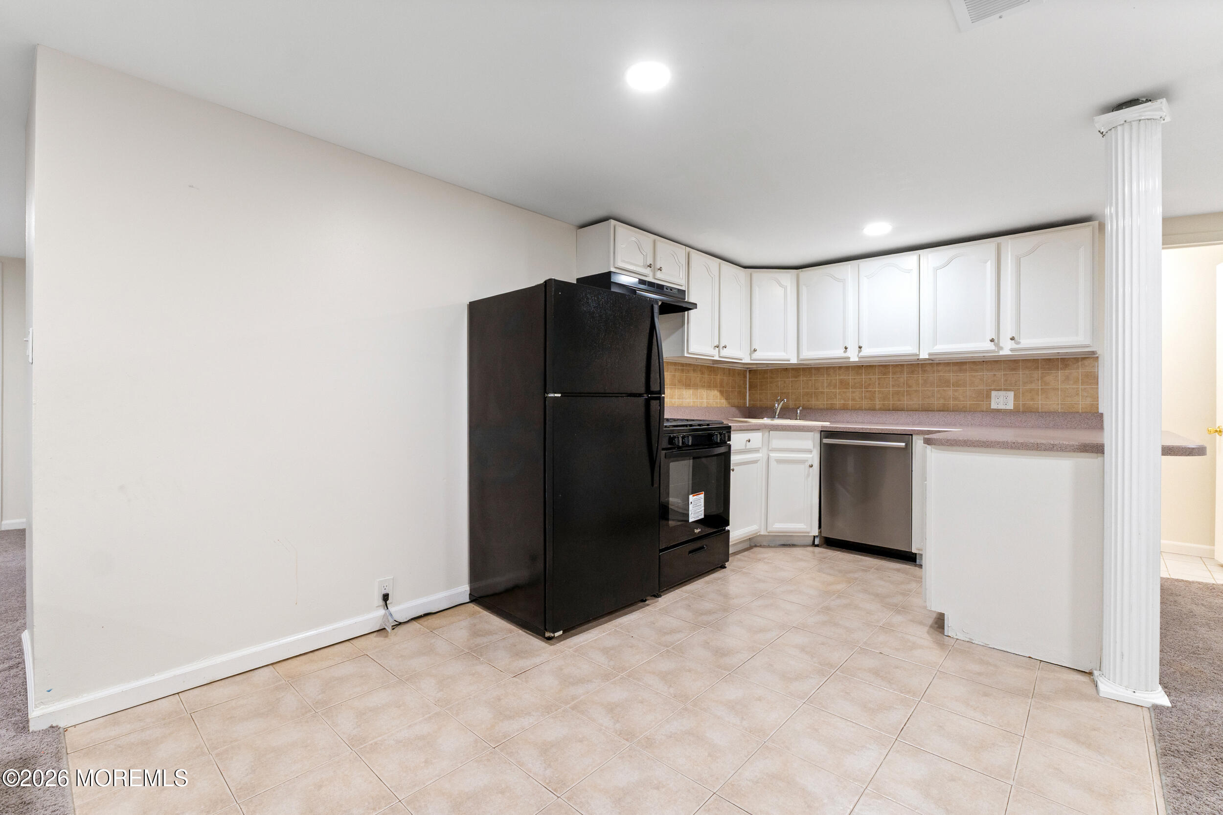 104 Autumn Road Matawan, NJ 07747 - Photo 45 of 64 a kitchen with a refrigerator and a sink