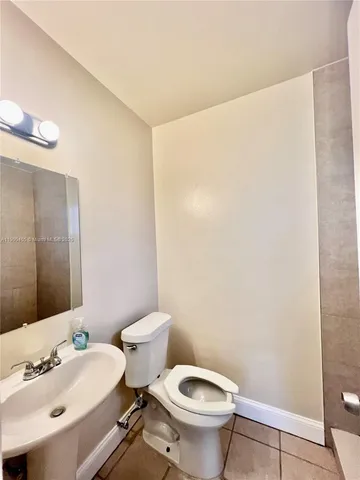 a white toilet sitting next to a bathroom sink