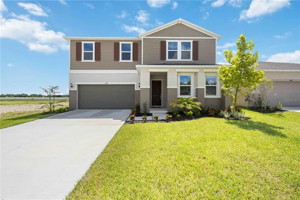 a front view of a house with swimming pool having outdoor seating