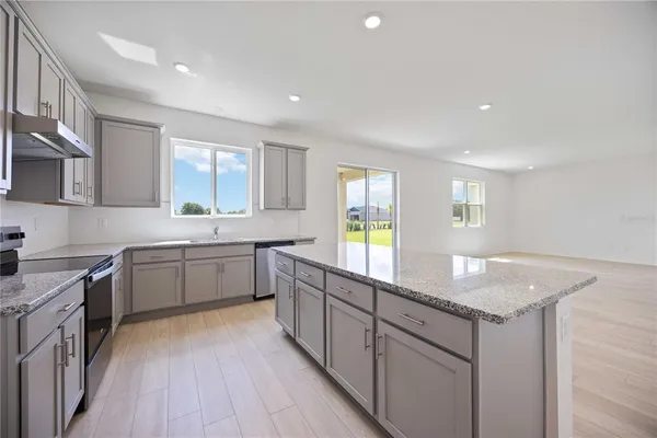 a kitchen with a sink stove and cabinets