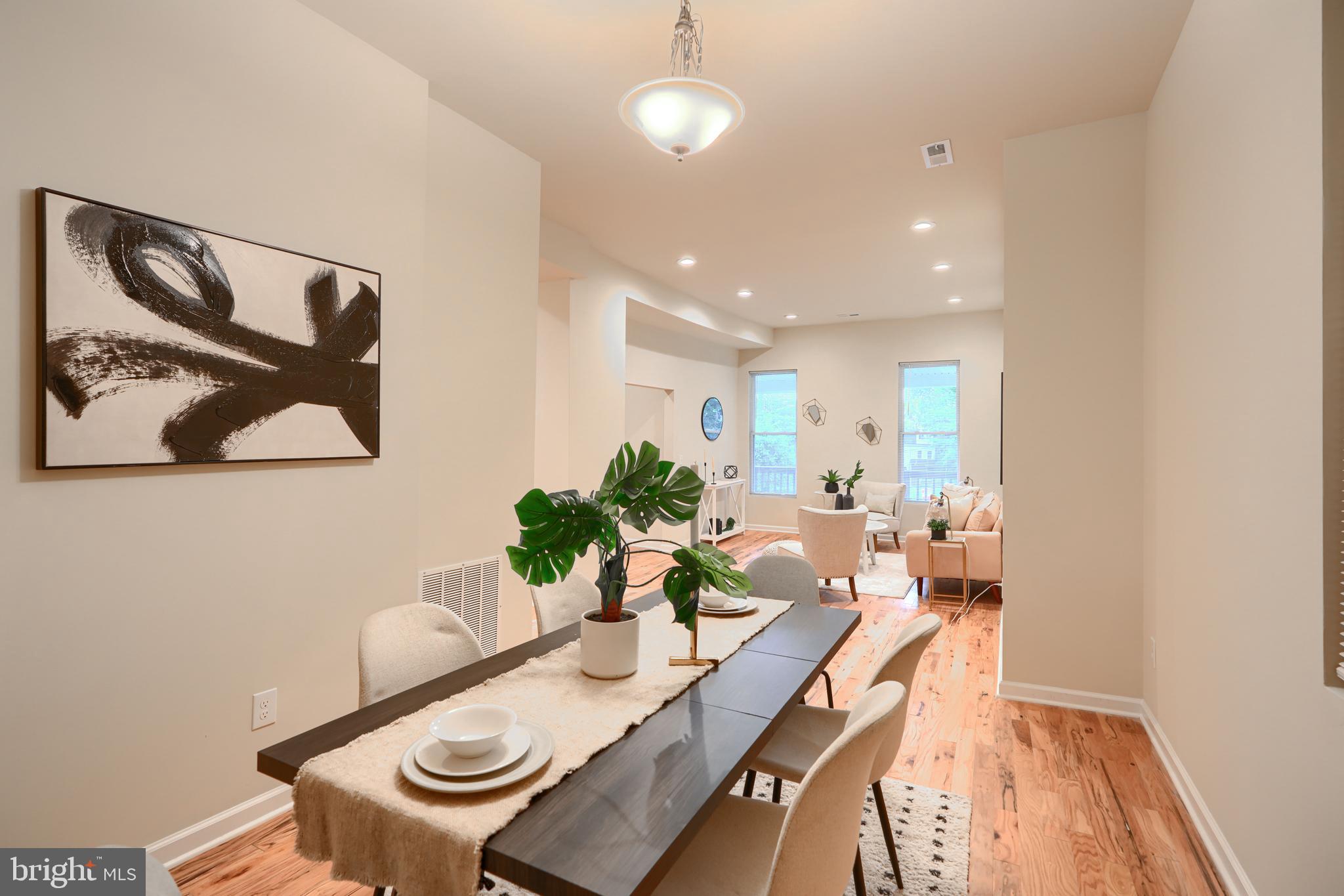 3308 Walbrook Avenue Baltimore, MD 21216 - Photo 11 of 32 a view of a dining room with furniture a rug and wooden floor