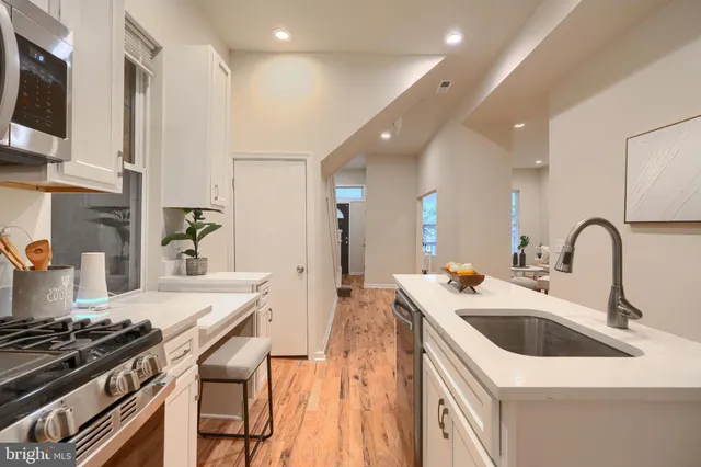 a kitchen that has a sink and a stove