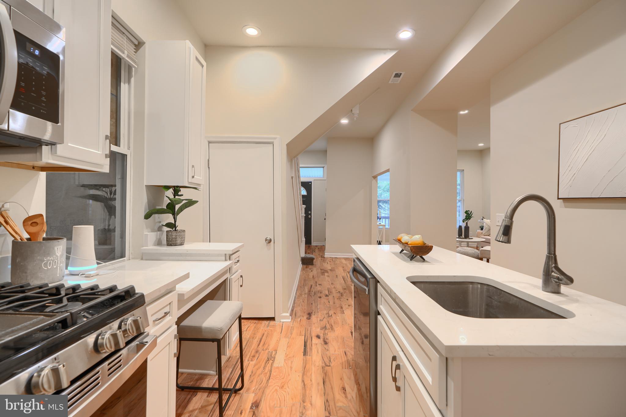 3308 Walbrook Avenue Baltimore, MD 21216 - Photo 14 of 32 a kitchen that has a sink and a stove