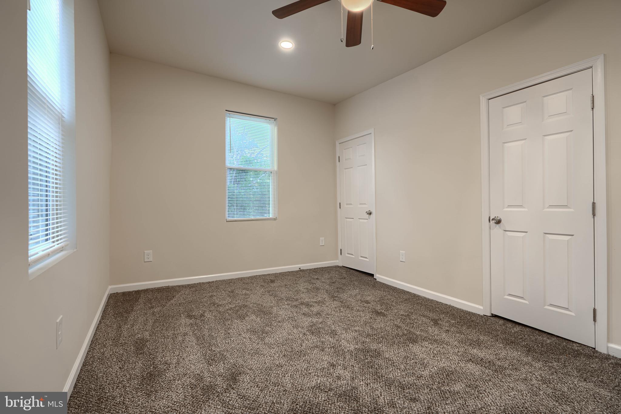 3308 Walbrook Avenue Baltimore, MD 21216 - Photo 16 of 32 an empty room with ceiling fan and windows