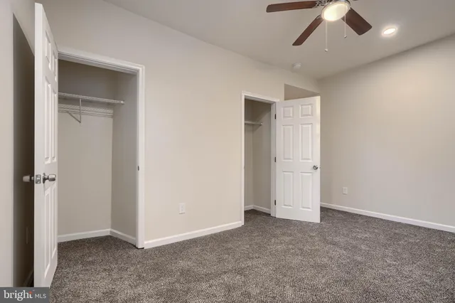 an empty room with a empty space and a ceiling fan
