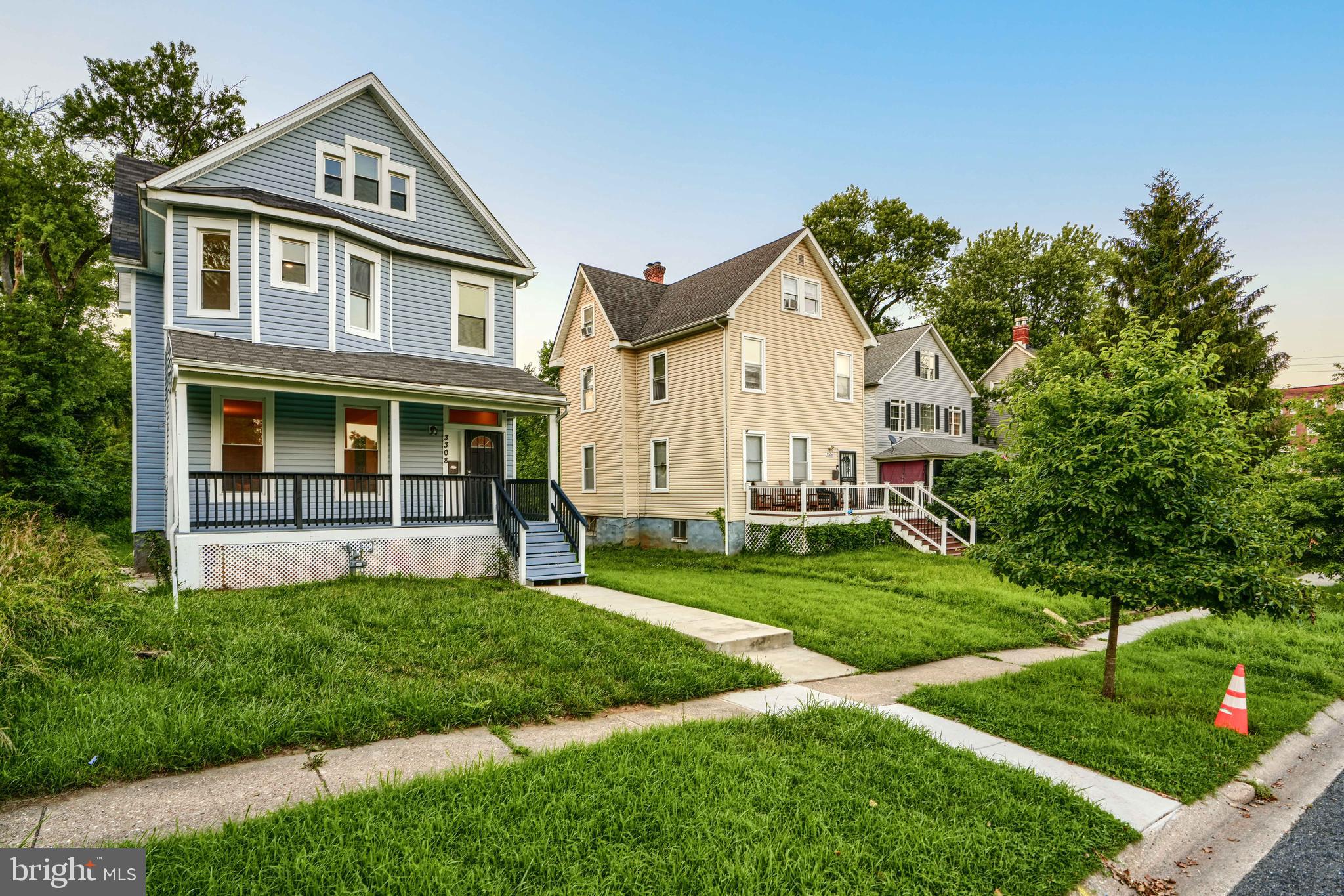 3308 Walbrook Avenue Baltimore, MD 21216 - Photo 2 of 32 a front view of a house with a yard and trees
