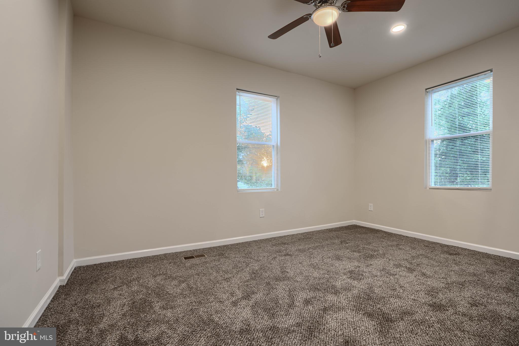 3308 Walbrook Avenue Baltimore, MD 21216 - Photo 21 of 32 an empty room with a window and a ceiling fan