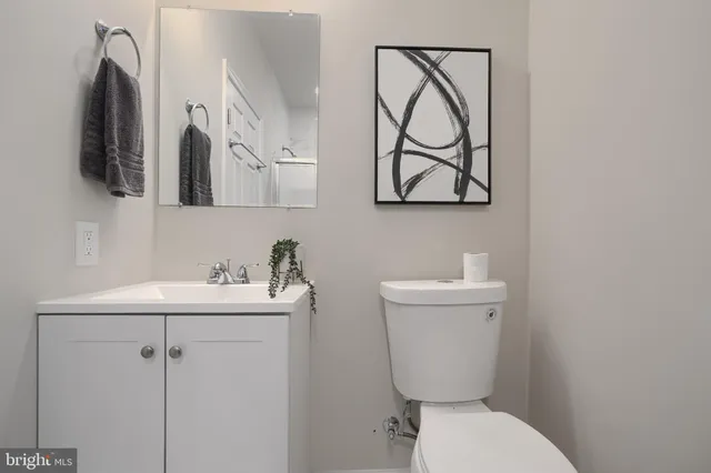 a bathroom with a toilet sink and mirror
