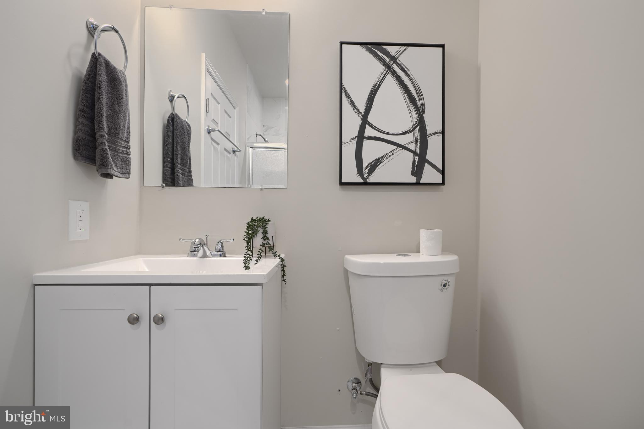3308 Walbrook Avenue Baltimore, MD 21216 - Photo 26 of 32 a bathroom with a toilet sink and mirror