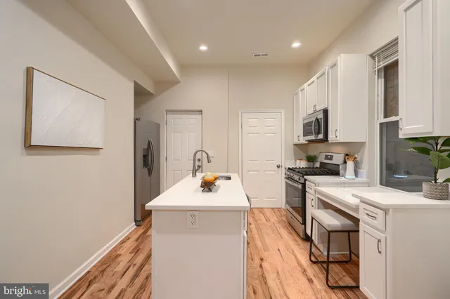 a kitchen that has a sink and a stove in it