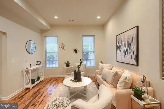 a living room with furniture and a wooden floor