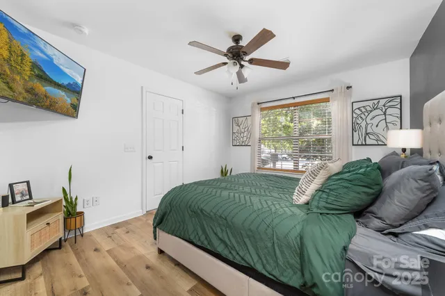 a living room with a bed furniture and a window