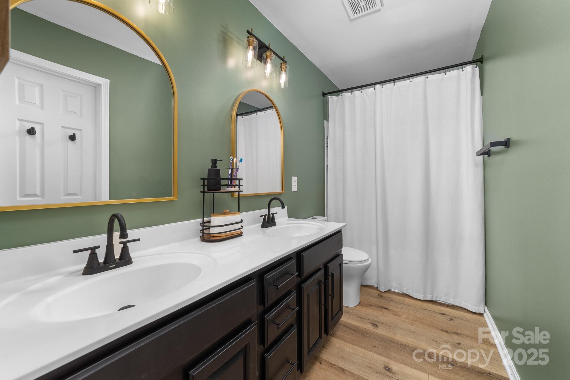 1542 Maypine Commons Way Rock Hill, SC 29732 - Photo 15 of 36 a bathroom with a double vanity sink and a mirror