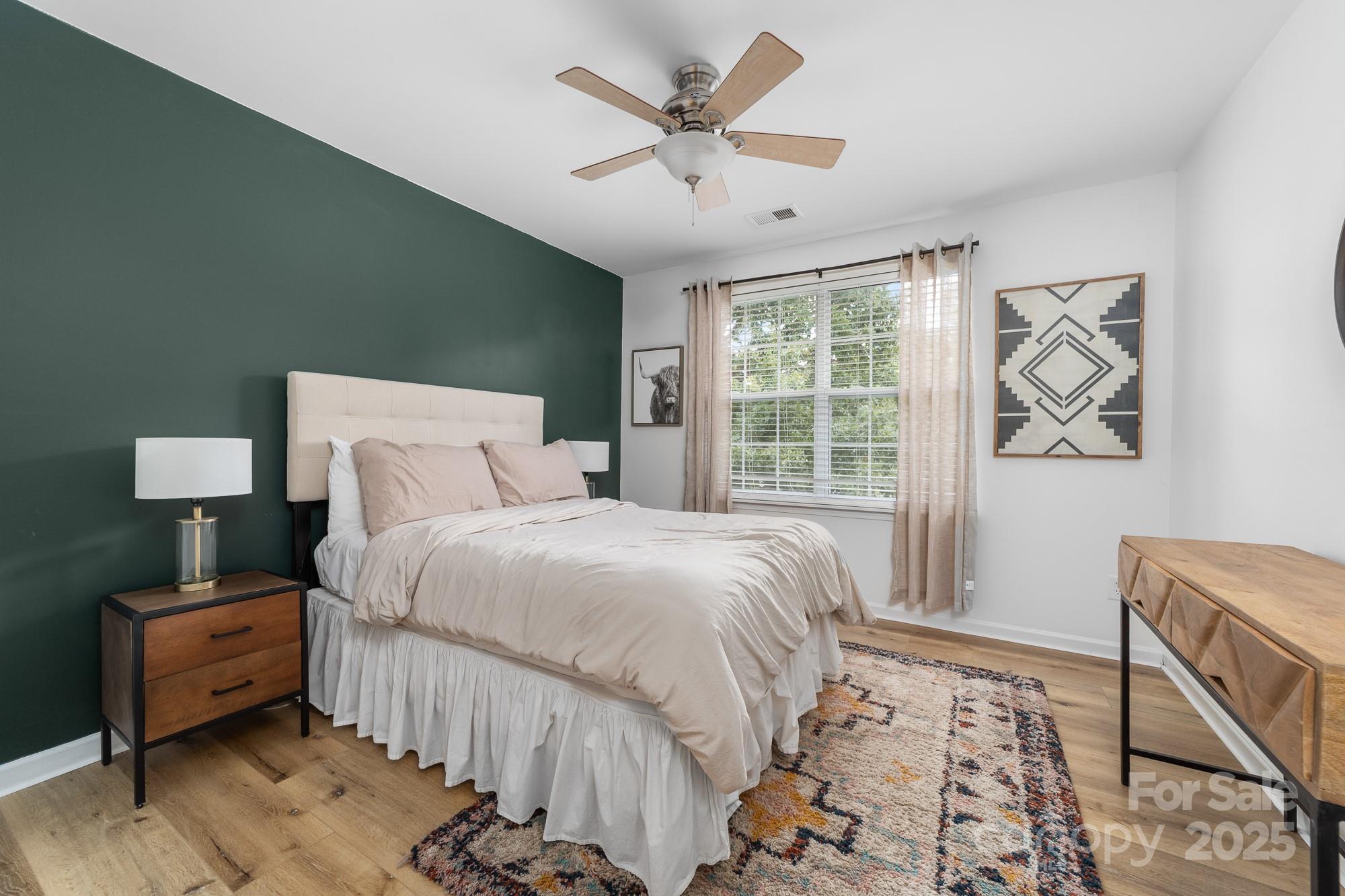 1542 Maypine Commons Way Rock Hill, SC 29732 - Photo 27 of 36 a bedroom with a bed and a large window