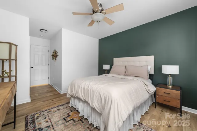 a bedroom with a bed and a lamp