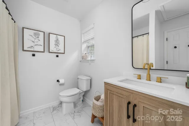 a bathroom with a sink toilet and mirror