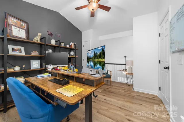 a living room with furniture a flat screen tv and a table