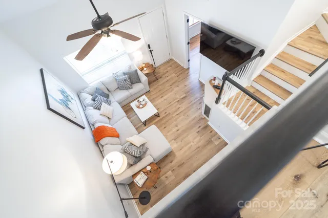 a living room with a bed and a television