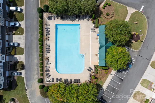 an aerial view of a residential apartment building with a yard and plants