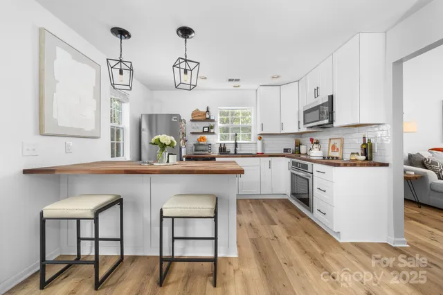 a kitchen with cabinets a sink and appliances in it